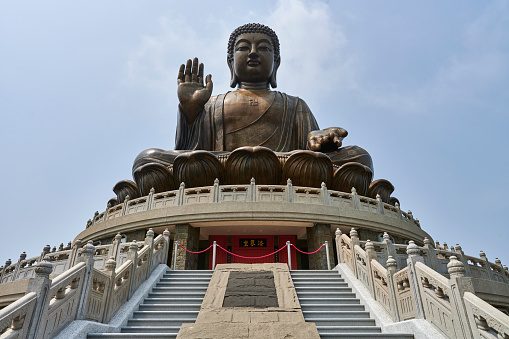 Detail of Lady Buddha statue in a Buddhist temple and blue sky background in Danang, Vietnam. Close up, copy space