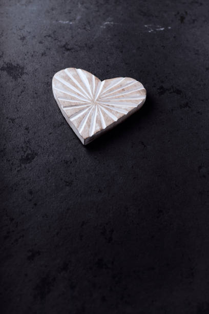 istock Wooden Heart on dark stone background. Soft focus. Copy space. 1482391280