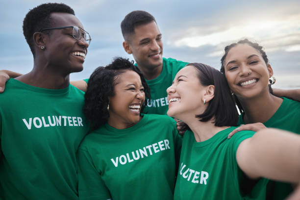 istock Teamwork, selfie and smile with people on beach for sustainability, environment and climate change. Charity, earth day and social media with group of volunteer for recycling, energy and pollution 1482392595
