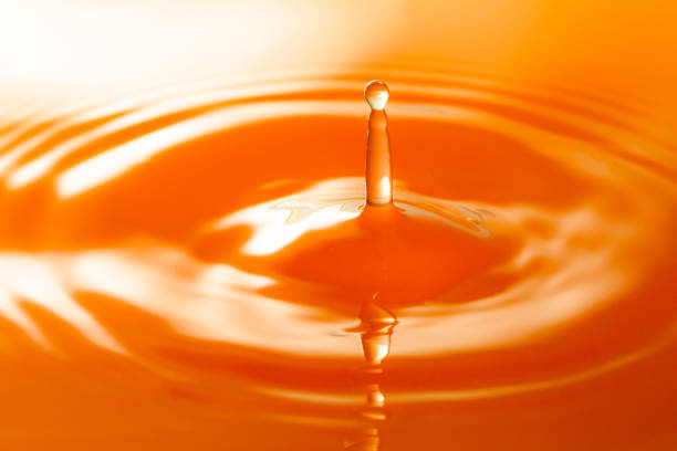 istock Macro orange drop,Macro orange water drop texture,Falling drop in orange water with splash,The waves after a few drops of orange juice 1482397177