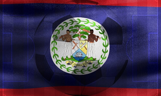 A photo of a waving Belize flag with a football ball-shaped outline in the center
