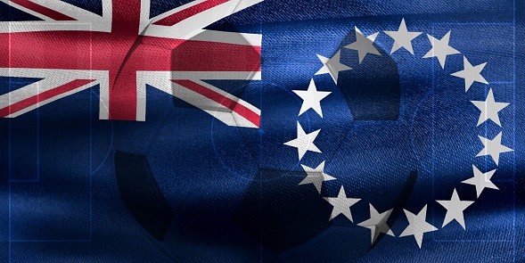 A photo of a waving Cook Islands flag with a football ball-shaped outline in the center