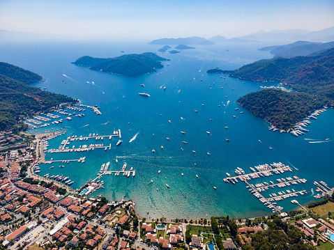 Aerial drone photo of the bustling Göcek Marina, located in the beautiful coastal town of Muğla, Turkey, captured by a drone showcasing the vibrant harbor and surrounding landscape.