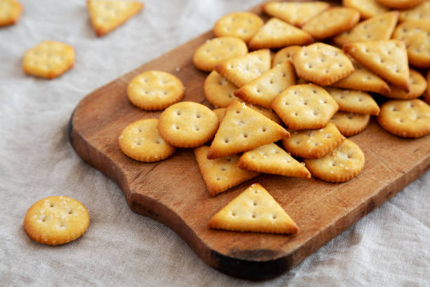 istock Homemade Salty Crackers on a Rustic Wooden Board, side view. 1482406030