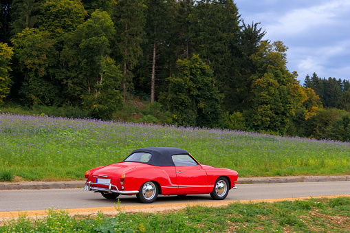 Heidenheim, Germany - October 3, 2021: Volkswagen Karmann-Ghia Typ 14 german oldtimer vintage cabrio sports car on a country road near Heidenheim an der Brenz, Germany.