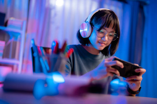 istock Asian girl playing game on phone at night having fun 1482406839
