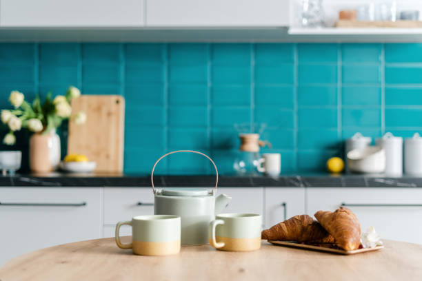 istock fresh pastry and mugs with drink on wood table at home kitchen 1482406919