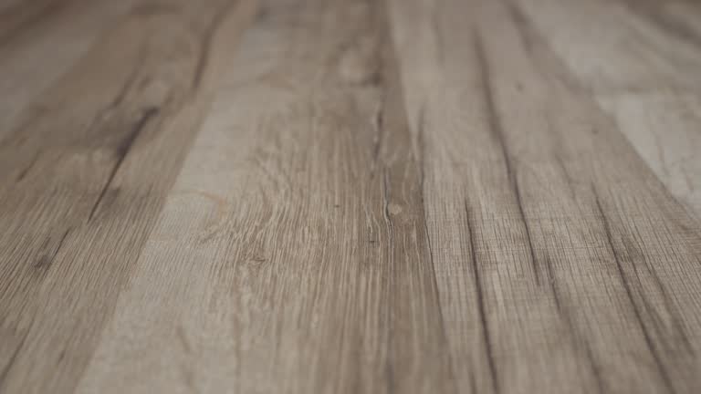 Close-up texture of light wooden parquet with natural pattern. Movement back. P