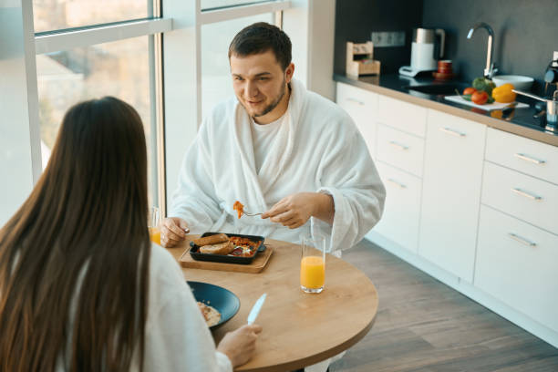 istock Young spouses chat nicely over breakfast in a cozy atmosphere 1482408313