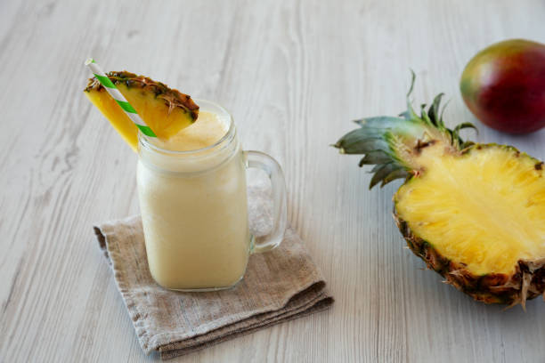 istock Homemade Pineapple Mango Banana Smoothie in a Glass Jar, side view. 1482410433