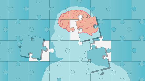 A man's profile is on puzzle pieces and his brain is completed with missing puzzle pieces. Mental health theme vector illustration.