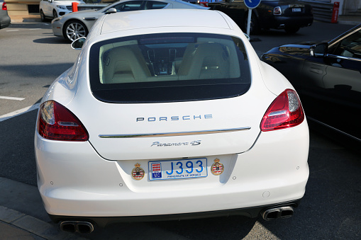 Monte-Carlo, Monaco - May 17, 2016: Rear view of a white Porsche Panamera 4S, parked in Monte Carlo, Monaco, with Automobile Club de Monaco emblems on the car body