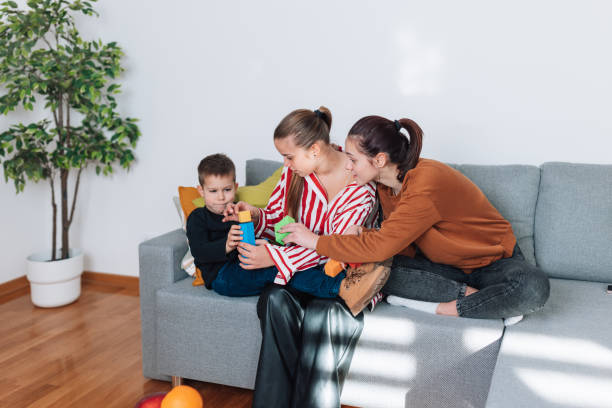 istock Sisters bonding with their little brother on the sofa 1482421668