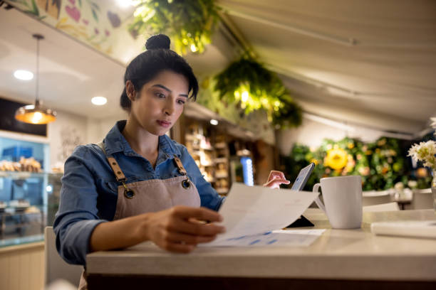 istock Business manager doing the accountancy at a cafe after closing 1482426120