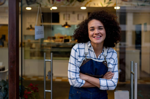 istock Happy waitress standing on the door at a cafe 1482426148