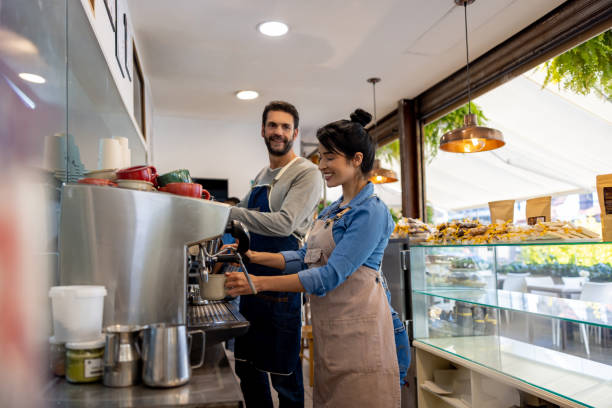 istock Happy baristas working at a cafe making coffee 1482426196