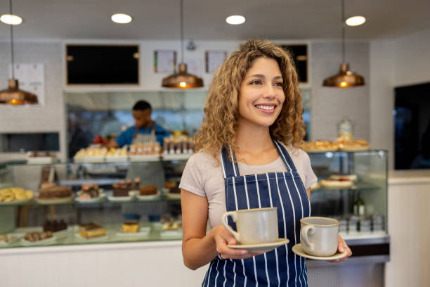 istock Happy waitress serving drinks at a coffee shop 1482426217