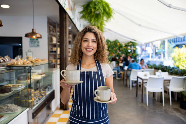istock Happy waitress serving coffee at a cafe 1482426220