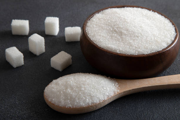 istock Cube sugar and granulated sugar on dark background 1482427353