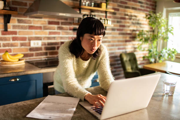 istock Young Asian Woman working from home on her laptop 1482427766