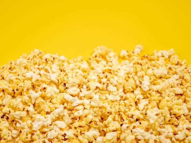 istock Popcorn on a yellow background. Sweet popcorn on yellow. 1482429747
