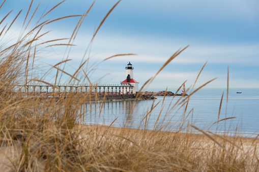 View of the Michigan City lighthouse from Washington Park Beach on a cloudy Spring morning.  Michigan City, Indiana, USA.