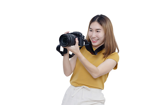 View of Asian Female Photographer Looking into Mirrorless Camera Viewfinder to Take Photos