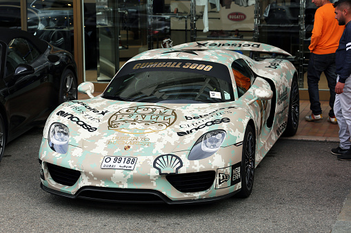 Monte-Carlo, Monaco - May 18, 2016: A striking Porsche race car with camouflage wrap and numerous stickers, participating in the Gumball 3000 rally, parked in Monte-Carlo, Monaco