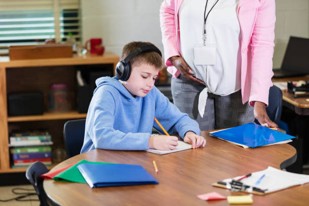 istock Student writing, wearing noise-cancelling headphones 1482447247