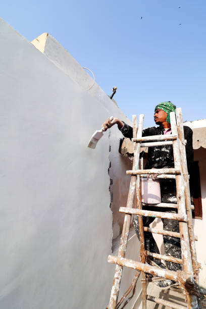 istock Painter painting the wall with paintbrush during New Year celebration 1482449257