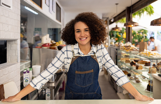 Waitress looking very happy working at a coffee shop