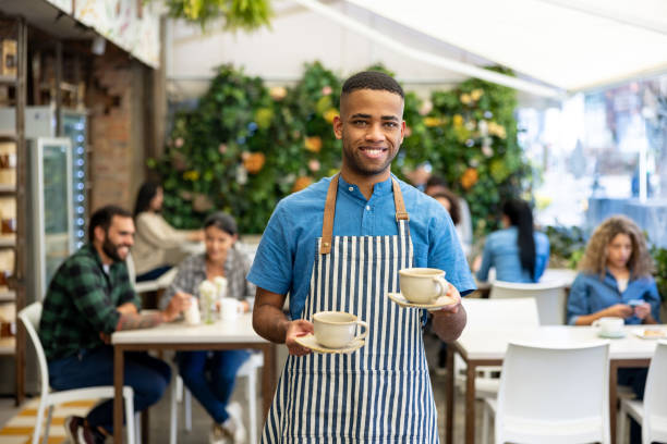 istock Happy waiter serving coffee at a coffee shop 1482449591