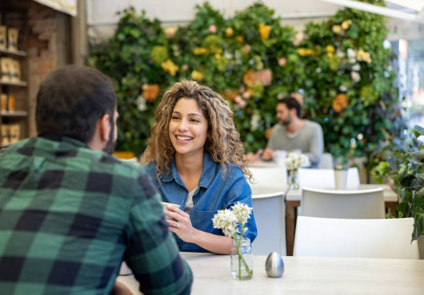 istock Happy woman smiling on a date at cafe 1482449603