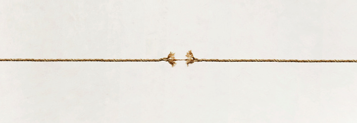 A long rope that is frayed and about to break.