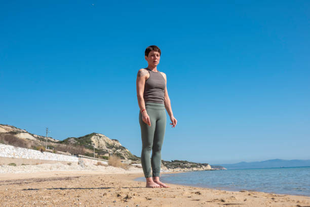 istock Woman practising yoga on the beach 1482454031
