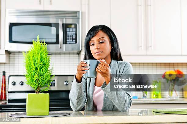 Woman In Kitchen With Coffee Cup Stock Photo - Download Image Now - Adult, Adults Only, African Ethnicity