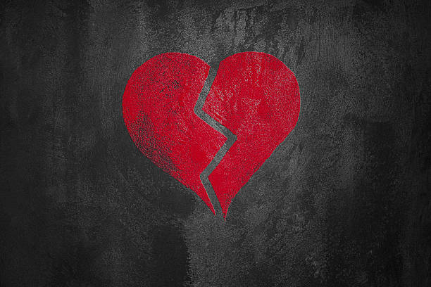 istock red broken  heart on abstract dark cement background 148245510