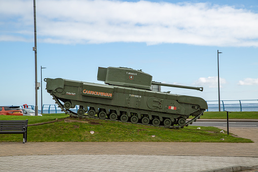 Carrickfergus, Northern Ireland - 2nd April 2023 : Churchill tank at Marine Gardens in Carrickfergus next to war memorial