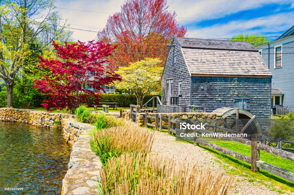Spring Color at the Old Mill Serving the town of Sandwich, Massachusetts from 1654 until 1880 this little grist mill on Shawme Pond was one of the longest running operations on this continent.  It continues operations in the summer months grinding corn for local people and visitors. Architecture Stock Photo