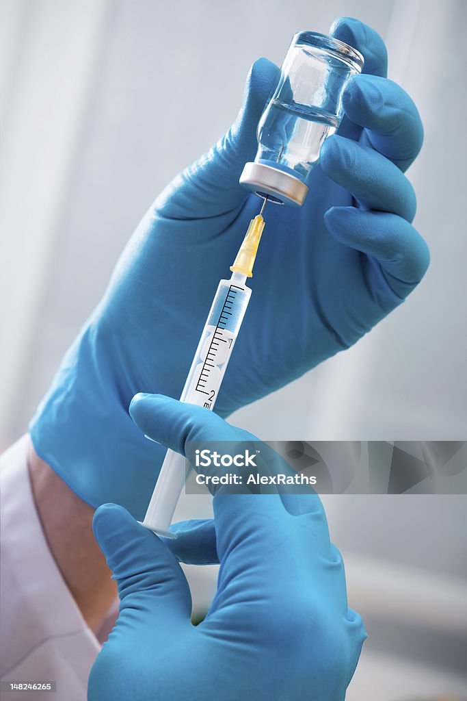 Injection Hands of the doctors filling a syringe Vaccination Stock Photo