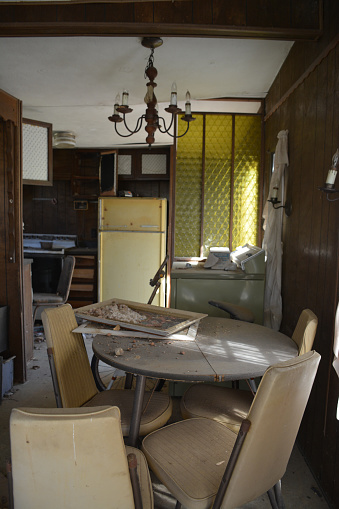 A dinette set remains in an abandoned mobile home.
