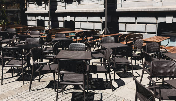 istock Empty restaurant summer terrace with tables and chairs. Reastaurant tables waiting for customers at an outdoor terrace. 1482466410
