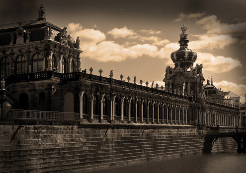 sepia toned view of the 18th century Dresden landmark building, the Kronentor, or crown gate, built in the Baroque style with an ornate crown marking the entrance to a palace complex
