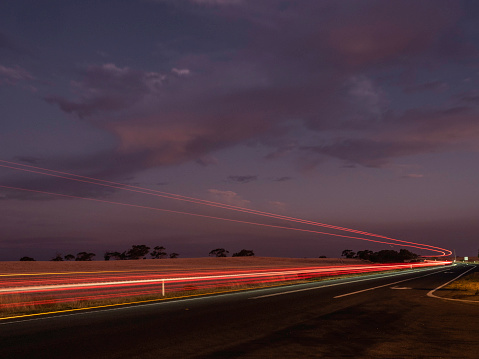 Truck light trails on a dark country road