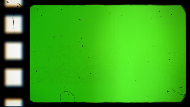Film frame texture with sprocket hole on green screen with grain, film dirt, dust, hair, leaks and scratches. Old Film reel strip rolling overlay. 4k resolution. Chroma key.