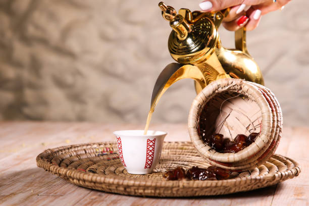 Arabic coffee with dates served with teapot in cup isolated on background top view ramadan food Arabic coffee with dates served with teapot in cup isolated on background top view ramadan food arabica coffee drink stock pictures, royalty-free photos & images