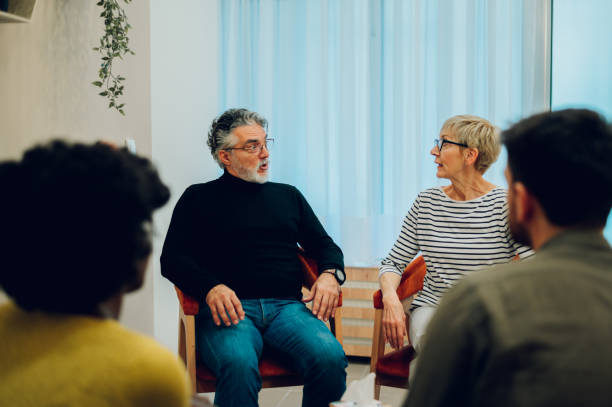 istock Senior people talking about their mental health on a group therapy session 1482487294