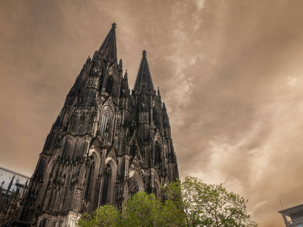 istock Cologne Cathedral seen from below with blue sky. Cologne Cathedral, or Kolner Dom, is the main landmark of Cologne and a catholic church in Germany. 1482488916