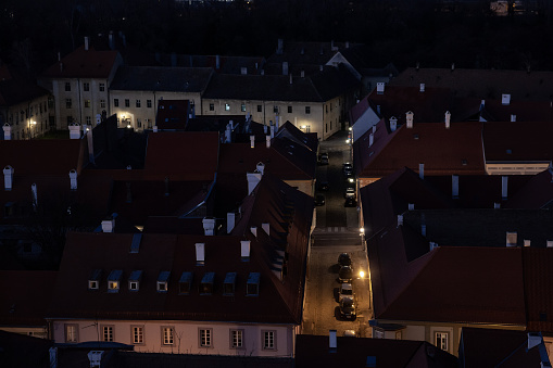 Picture of traditional roofs of buildings, used for residential purposes, typical from the central European architecture, taken in the district of Petrovaradin, in Novi Sad, Serbia, at night.