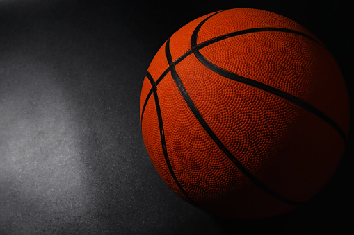 a orange basketball on dark background